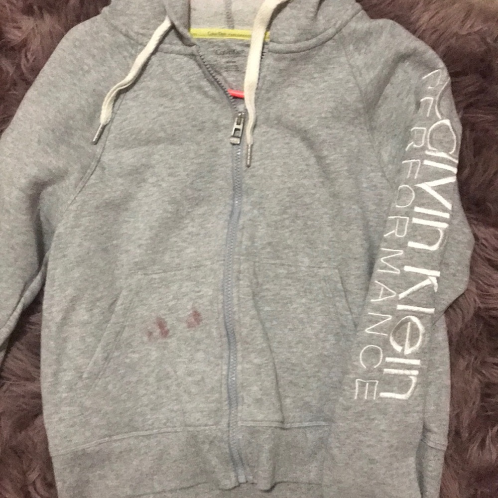 Calvin Klein zip up with tiny red lipstick stain